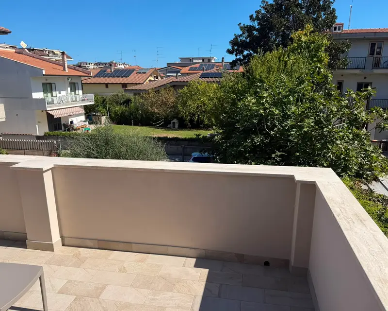 The paved terrace looking over gardens and rooftops