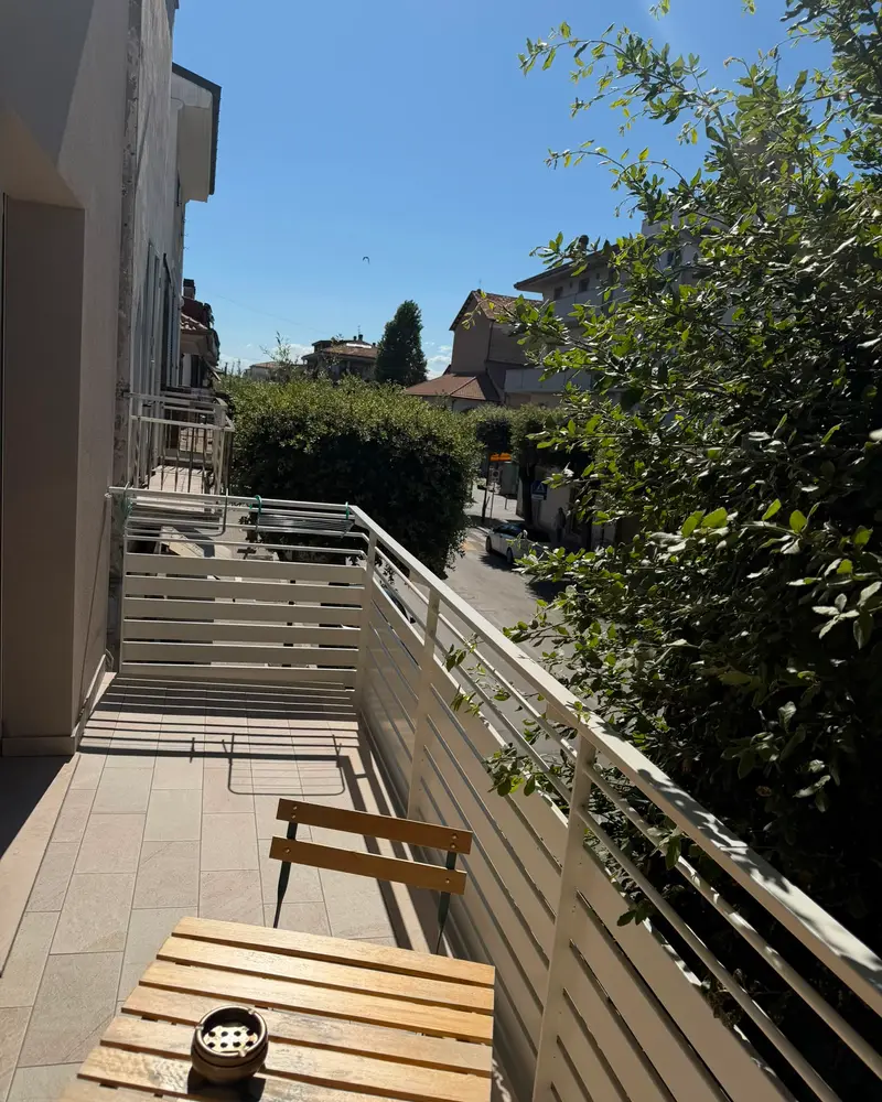 The B&B balcony, with a wooden table, overlooking the street